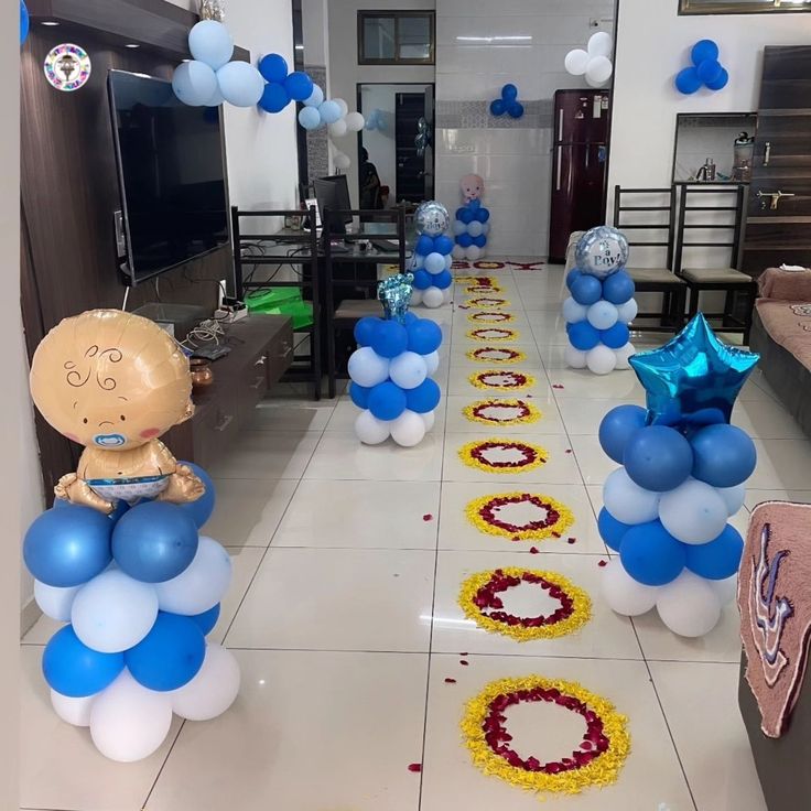 Blue balloon columns beside a floral welcome walkway