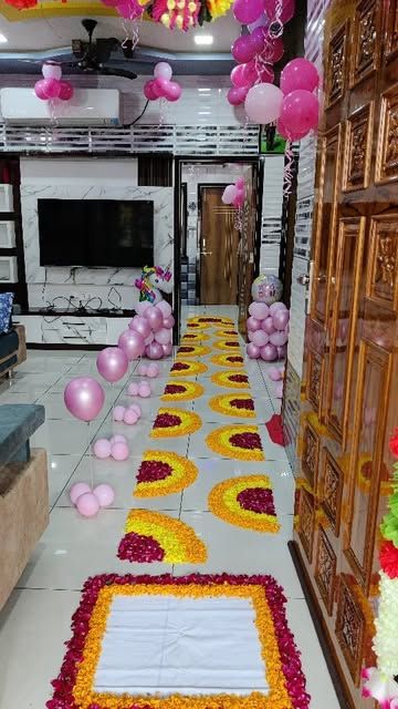 Pink balloon decorations and a flower-petal path at a home entrance